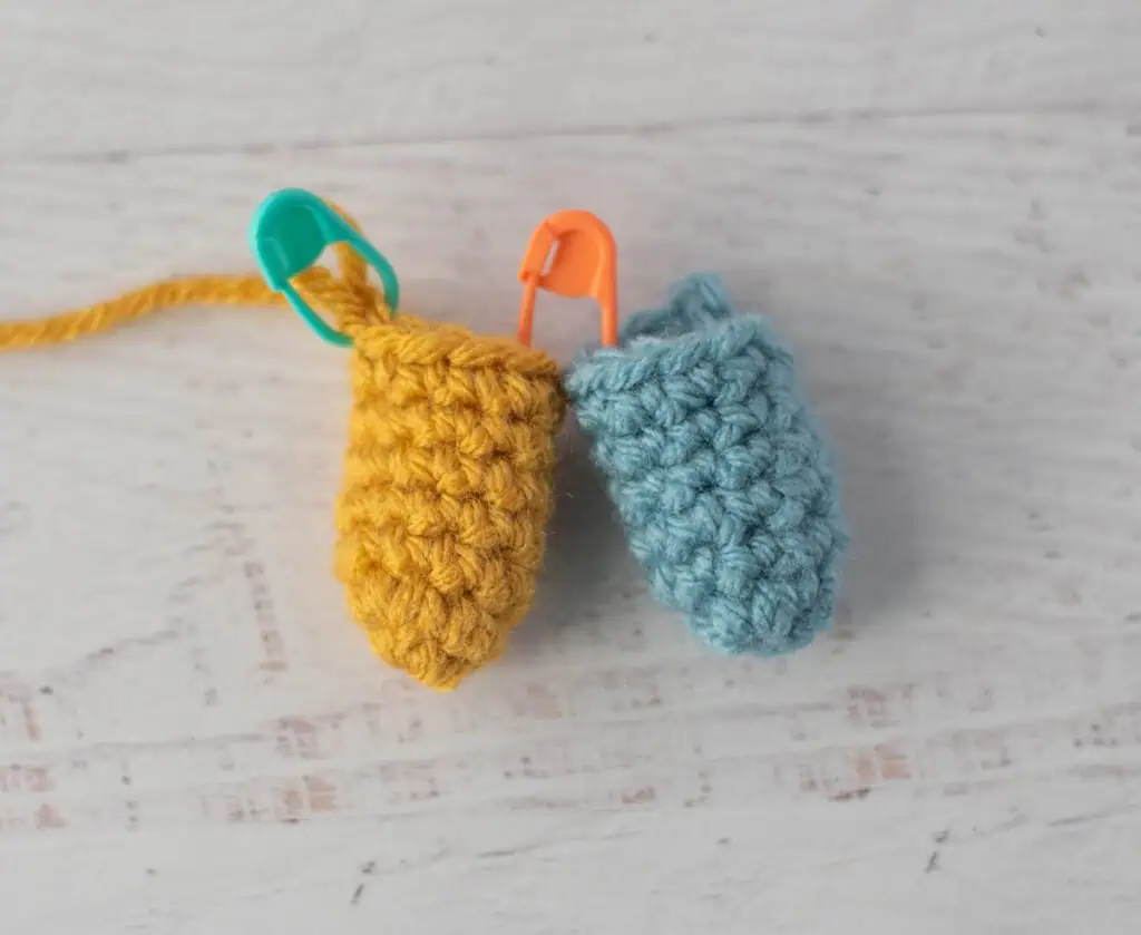crochet limb connection process with yellow and blue yarn