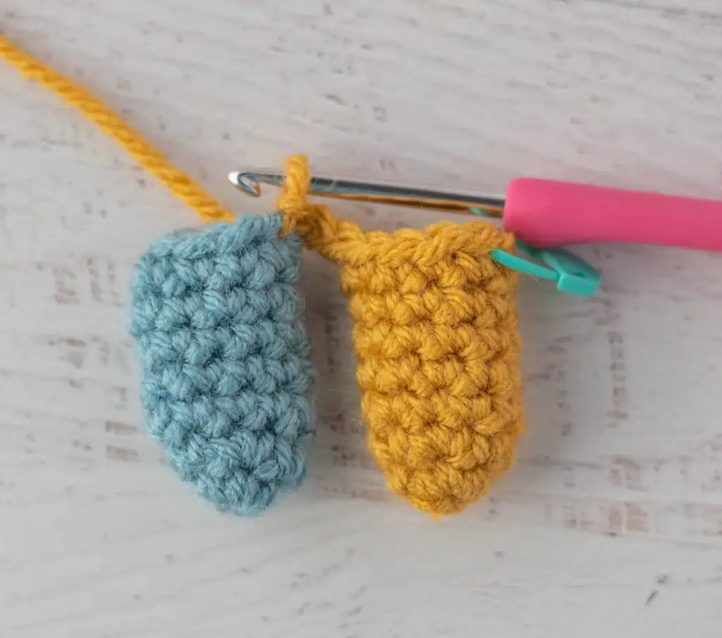 crochet limb connection process with yellow and blue yarn